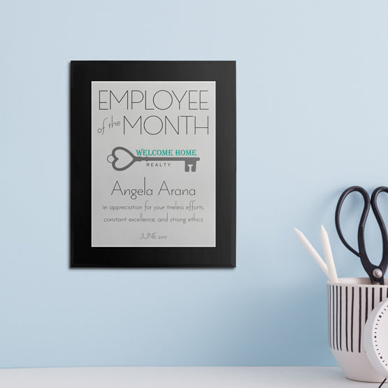 Modern Employee Of The Month Plaque With Custom Name And Logo On Wall Above White Desk.