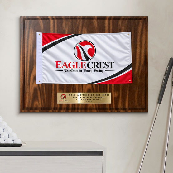 Walnut Plaque With White Golf Themed Flag And Gold Plate Printed With Golf Award Message Mounted On Wall Near Golf Club