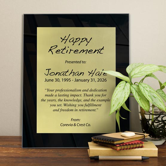 Gold Aluminum Plaque With Black Acrylic Board And Printed With Happy Retirement Message On Shelf With Plant And Notebooks