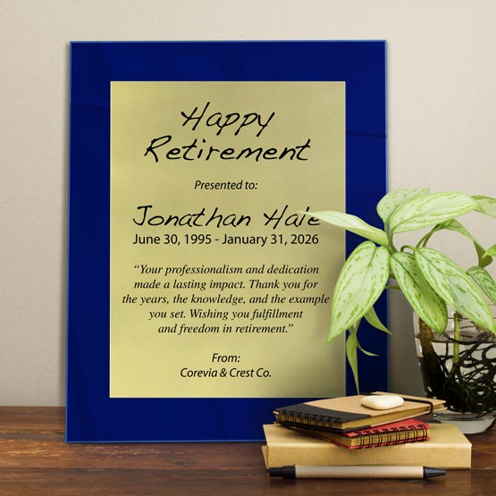 Gold Aluminum Plaque With Blue Acrylic Board And Printed With Happy Retirement Message On Shelf With Plant And Notebooks
