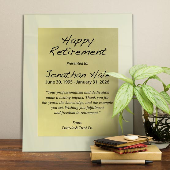 Gold Aluminum Plaque With Ivory Acrylic Board And Printed With Happy Retirement Message On Shelf With Plant And Notebooks