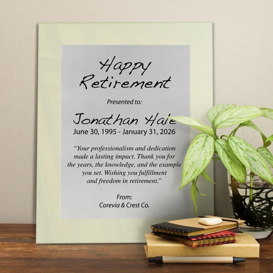 Silver Aluminum Plaque With Ivory Acrylic Board And Printed With Happy Retirement Message On Shelf With Plant And Notebooks
