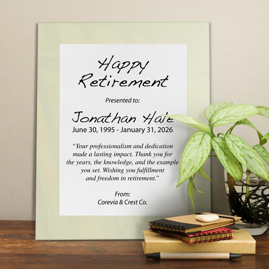 White Aluminum Plaque With Ivory Acrylic Board And Printed With Happy Retirement Message On Shelf With Plant And Notebooks