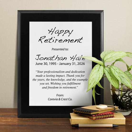White Aluminum Plaque With Black Board And Printed With Happy Retirement Message On Shelf With Plant And Notebooks