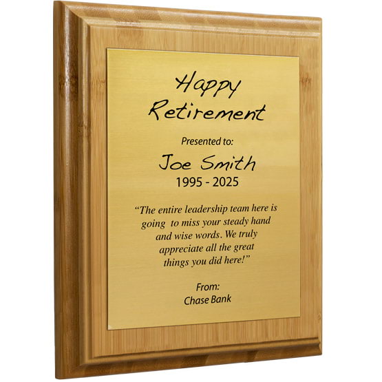 Custom Gold Aluminum Plaque With Bamboo Board And Printed With Happy Retirement Message Against A White Background