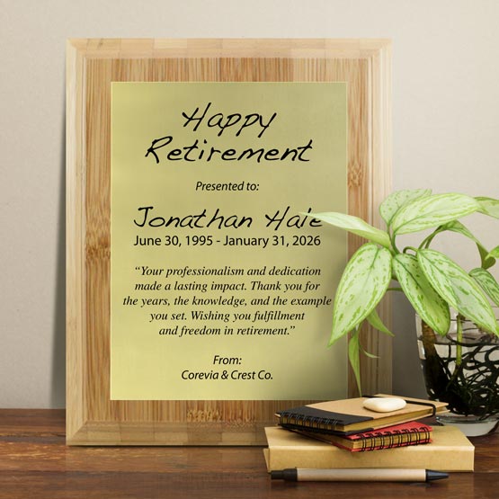 Gold Aluminum Plaque With Bamboo Board And Printed With Happy Retirement Message On Shelf With Plant And Notebooks