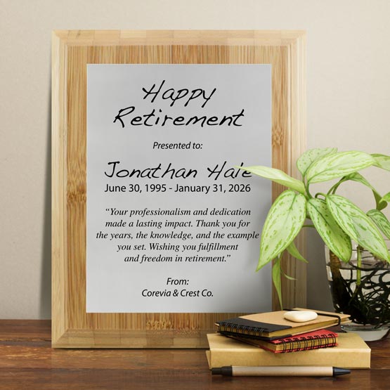 Silver Aluminum Plaque With Bamboo Board And Printed With Happy Retirement Message On Shelf With Plant And Notebooks