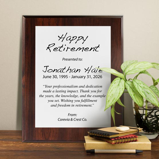 White Aluminum Plaque With Cherry Board And Printed With Happy Retirement Message On Shelf With Plant And Notebooks