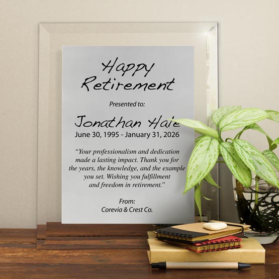 Silver Aluminum Plaque With Glass Board And Printed With Happy Retirement Message On Shelf With Plant And Notebooks