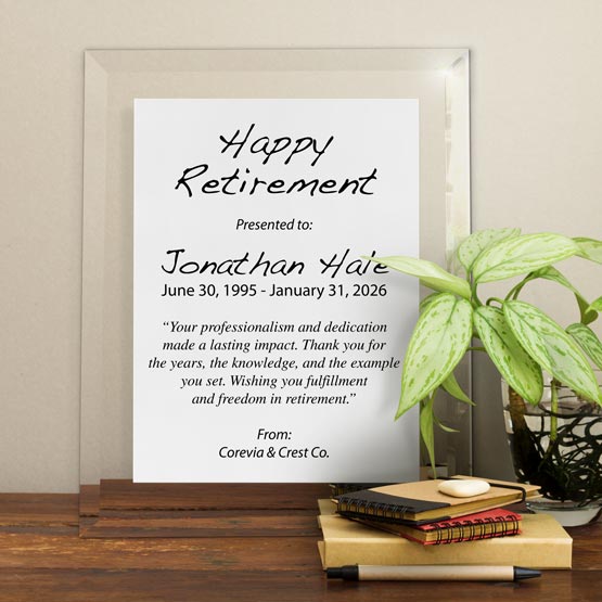 White Aluminum Plaque With Glass Board And Printed With Happy Retirement Message On Shelf With Plant And Notebooks