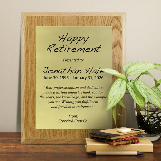 Gold Aluminum Plaque With Oak Board And Printed With Happy Retirement Message On Shelf With Plant And Notebooks