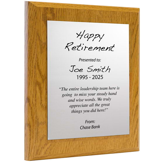 Custom Silver Aluminum Plaque With Oak Board And Printed With Happy Retirement Message Against A White Background
