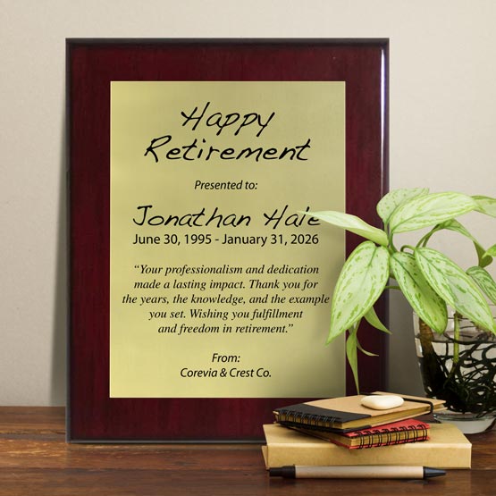 Gold Aluminum Plaque With Rosewood Board And Printed With Happy Retirement Message On Shelf With Plant And Notebooks