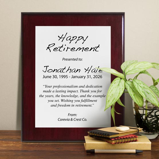White Aluminum Plaque With Rosewood Board And Printed With Happy Retirement Message On Shelf With Plant And Notebooks