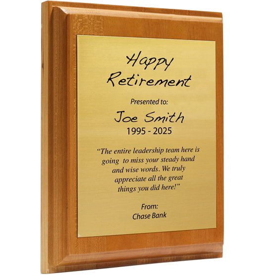 Custom Gold Aluminum Plaque With Solid Cherry Board And Printed With Happy Retirement Message Against A White Background