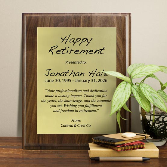 Gold Aluminum Plaque With Solid Walnut Board And Printed With Happy Retirement Message On Shelf With Plant And Notebooks