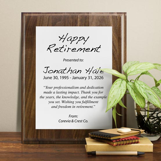 White Aluminum Plaque With Solid Walnut Board And Printed With Happy Retirement Message On Shelf With Plant And Notebooks