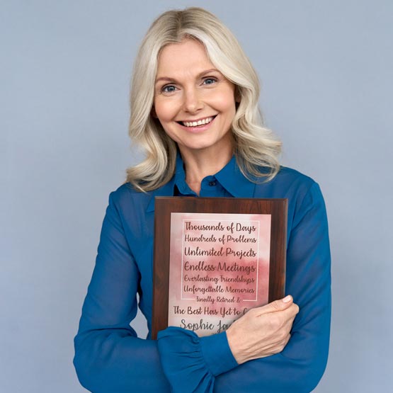 Happy Woman Holding Custom Aluminum Plaque With Watercolor Design And Retirement Appreciation Message And Name On Wood Board
