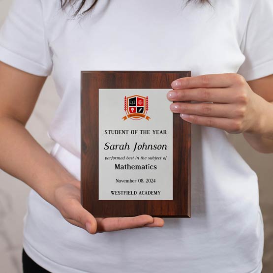 Girl Holding Custom Aluminum Plaque Award For Student Of The Year With School And Student Details On A Wood Board