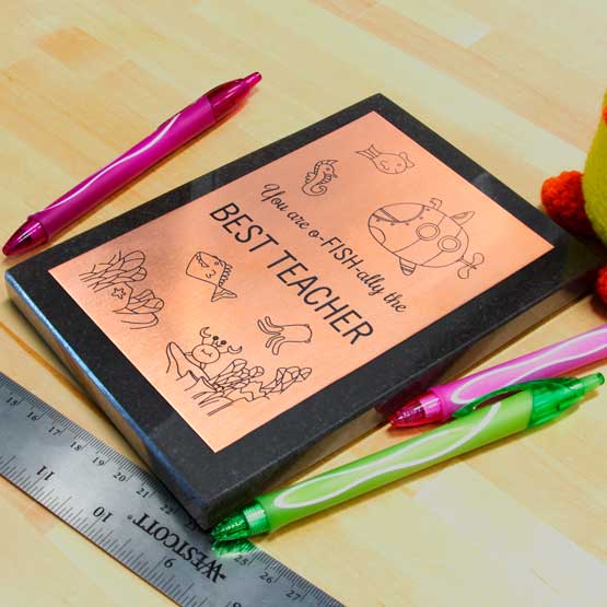 Custom Copper Award Plaque For Best Teacher With Cute Ocean Life Artwork And Granite Board On Busy Teacher Desk