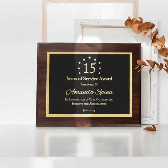 Custom Laser Engraved Metal Plaque With Wood Board And Years Of Service Award Message On A White Shelf With Plant