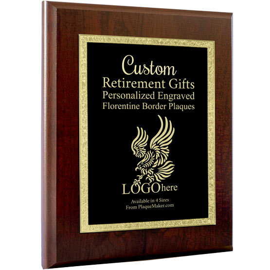 A black metal plate with a decorative golden boarder on a wooden board with gold engraved text and placeholder art, set at a slight angle on a white background.