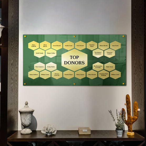 Top Donor Perpetual Plaque With Green Acrylic Board And Gold Honeycomb Plates With Names On Office Wall Over Shelf With Decor