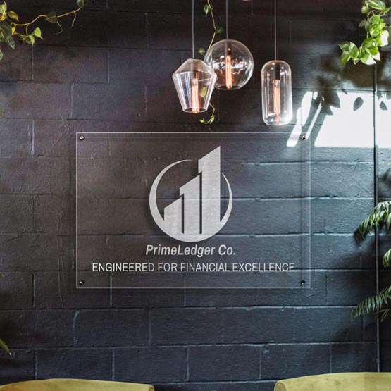 Clear Acrylic Sign Engraved With Financial Business Logo And Slogan Mounted Onto Brick Office Wall Via 4 Silver Standoffs
