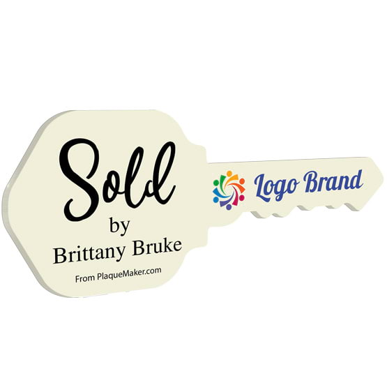House Key Shaped Ivory Acrylic Sign Color Printed With Sold By Message And Sample Logo And Name Against White Background