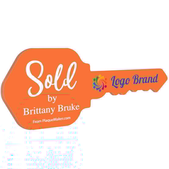 House Key Shaped Orange Acrylic Sign Color Printed With Sold By Message And Sample Logo And Name Against White Background