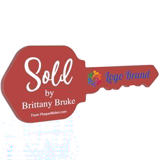 House Key Shaped Red Acrylic Sign Color Printed With Sold By Message And Sample Logo And Name Against White Background