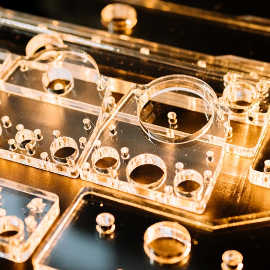 Close-up of clear acrylic components cut by laser.