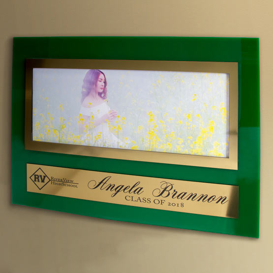 Green Acrylic Sign With Gold Plastic Picture Frame Featuring Student Photo And Plate With Graduate Details Mounted On Wall