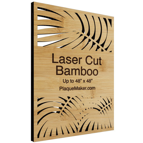 Laser cut bamboo sign with leaf patterns and text on a white background