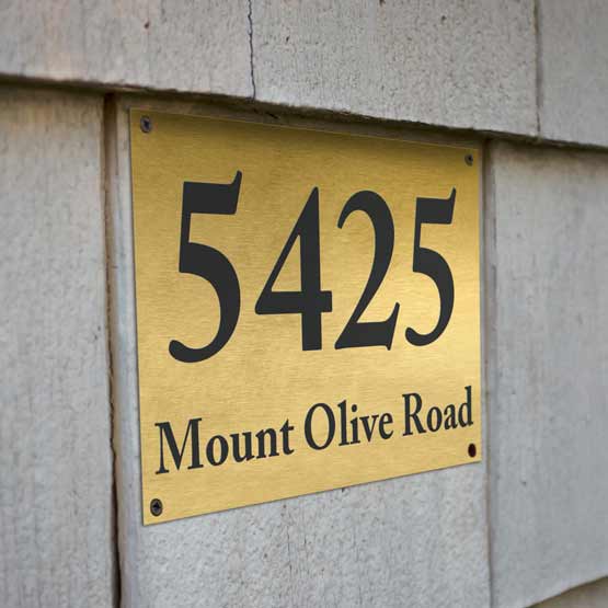 Custom Brass Address Sign Laser Fused With Address Number And Mount Olive Road Text Mounted Outdoors On Gray Brick Wall