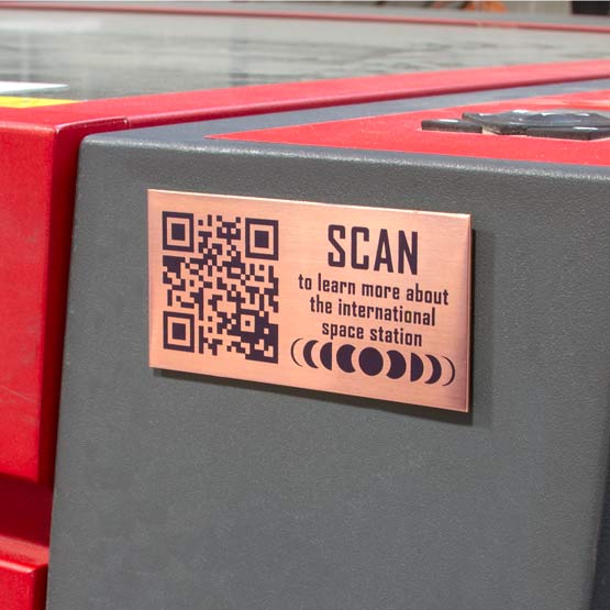 Copper QR Code Label Laser Fused With QR Code And Scan To Learn More Message Mounted On Museum Learning Console Station