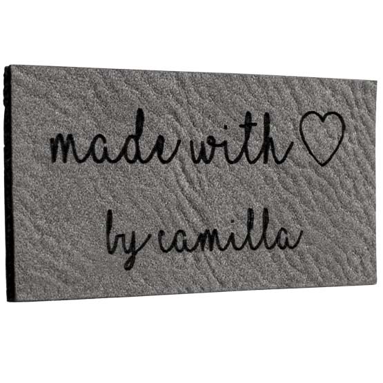 Custom Gray And Black Faux Leather Label Engraved With Cursive Made With Love By Camila Message Featuring Heart Art