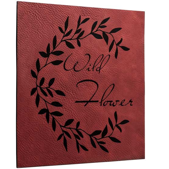 Custom Rose And Black Faux Leather Sign Laser Engraved With Plant Artwork And Wild Flower Text Against White Background