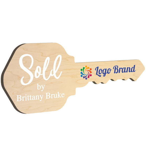 House Key Shaped Maple Wood Sign Color Printed With Sold By Message And Sample Name And Logo Against White Background