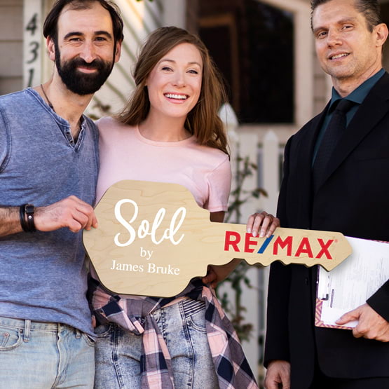 Realtor Posing Outdoors With Happy Couple Holding House Key Shaped Maple Wood Sign Printed With Sold By Message And Logo