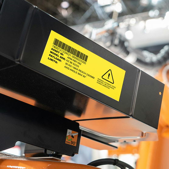 Yellow Plastic Bar Code Tag Engraved With Warning Icon And Equipment Model Details Mounted Directly Onto Machinery
