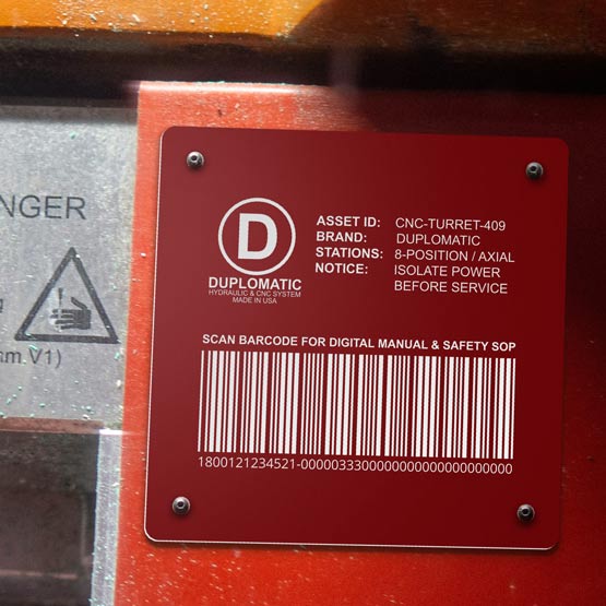 Red Plastic Bar Code Tag Engraved With Logo And Hydraulic System Details And Barcode Mounted Onto Equipment