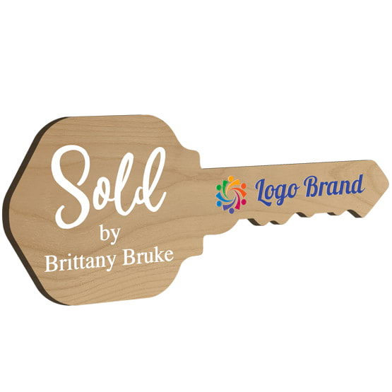 House Key Shaped Red Alder Wood Sign Color Printed With Sold By Message And Sample Name And Logo Against White Background