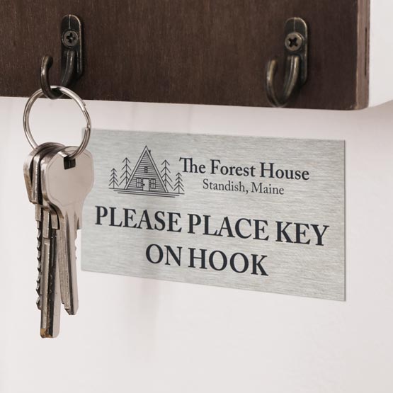 Stainless Steel Label Laser Fused With Forest House Logo And Details And Place Key On Hook Message On Wall Beneath Key Hook