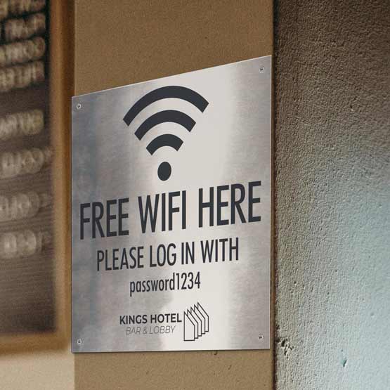 Stainless Steel WiFi Sign Laser Fused With WiFi Icon And Free WiFi Here Text Login Details And Logo Mounted On Wall