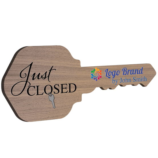 House Key Shaped Walnut Wood Sign Color Printed With Just Closed Message And Sample Name And Logo Against White Background