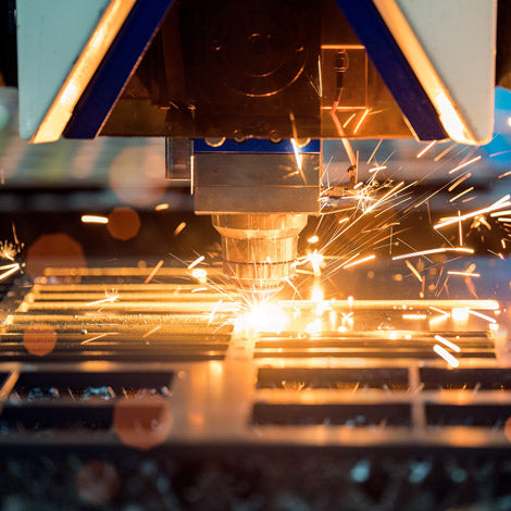 Laser cutting machine in action with sparks flying
