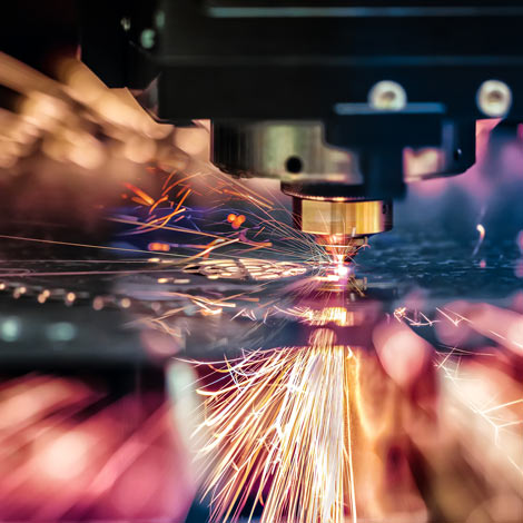 CNC Laser cutting machine in action with sparks flying