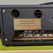 Order 781933 Review Image 1. Brass sign attached to the back of an amp. It lists the details of manufacturing.