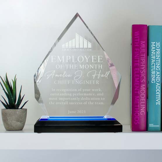 Fully customizable diamond acrylic award on a blue mirrored base, sitting on a shelf to display an achievement or award.